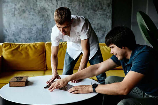 adults playing with a wooden puzzle