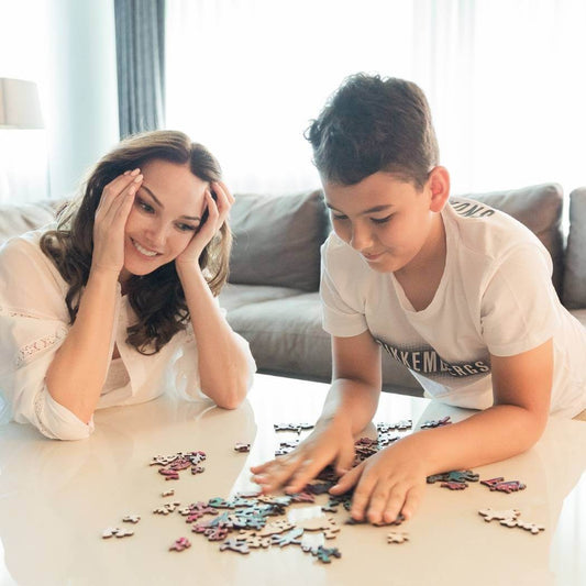 Mother with son assembling mystic fish wooden puzzle